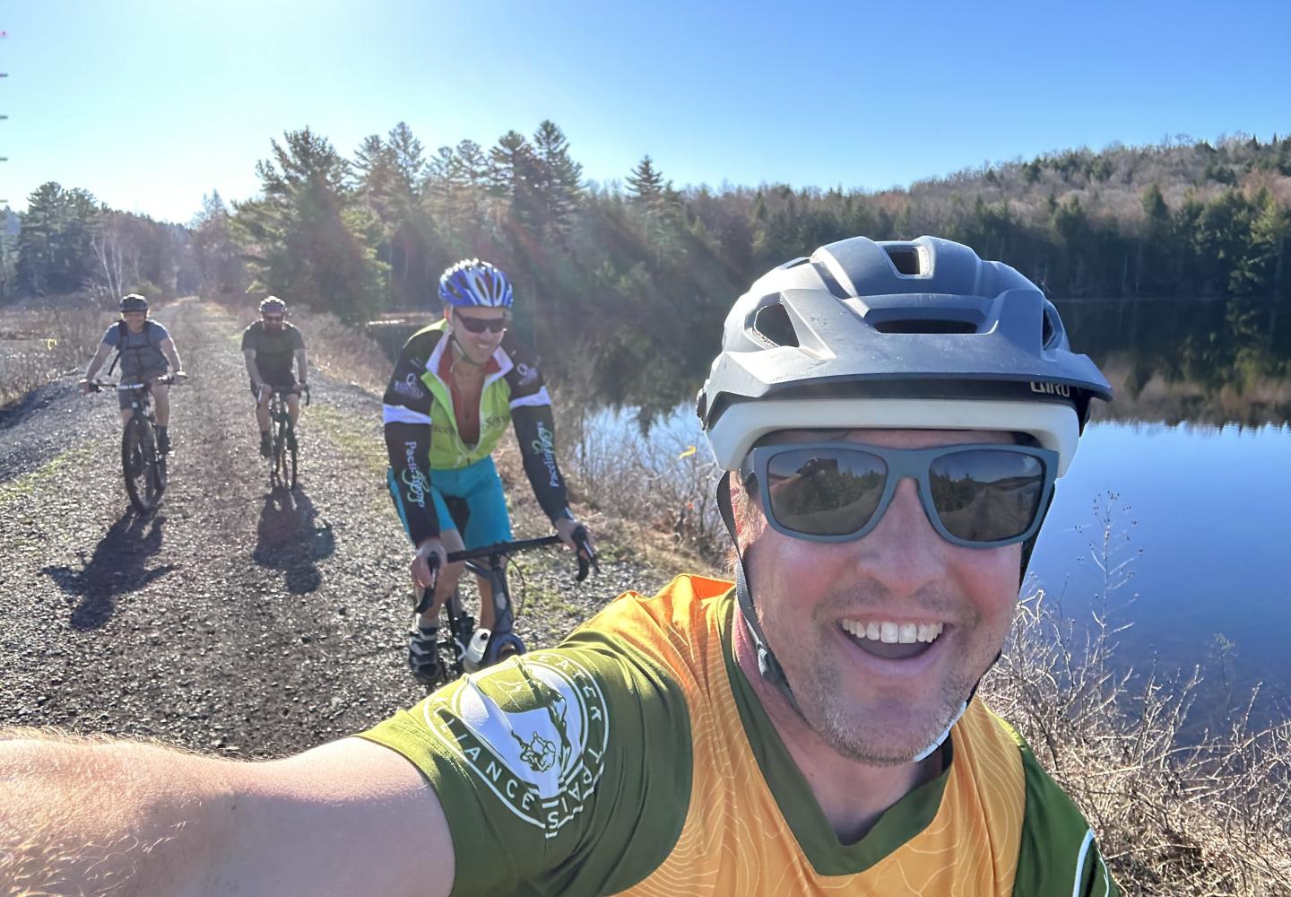 A group of cyclists enjoys the section between Saranac Lake and Lake Clear in April 2023.