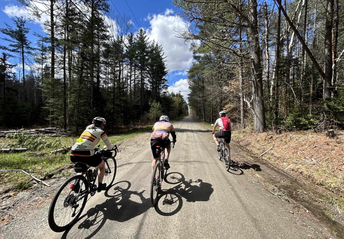 Cyclists enjoy an unfinished section of the Adirondack Rail Trail.