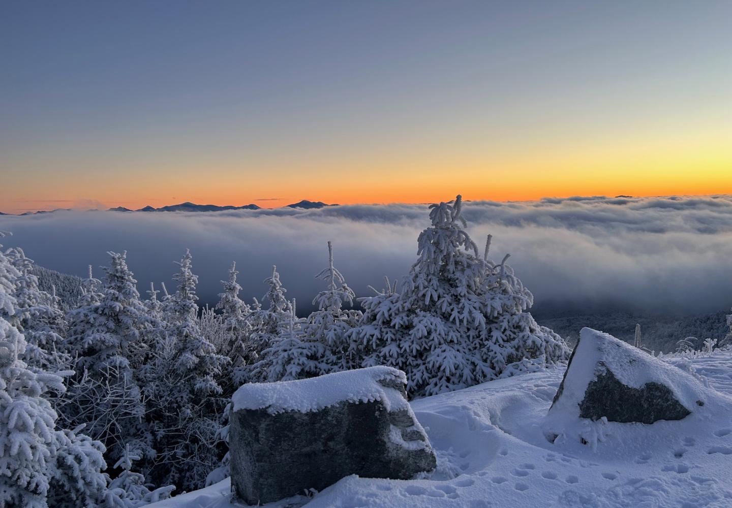 The sun sets on January 1, 2024 as clouds fill the Adirondack Valley below.