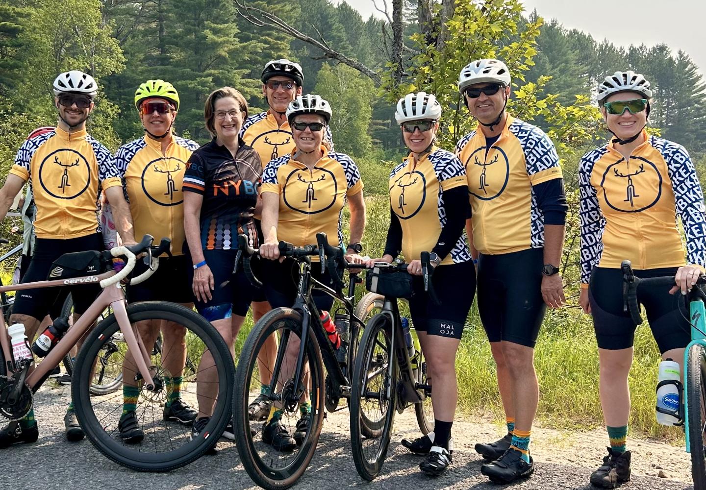 Anne Savage poses with Bike Adirondacks incredible support team, the Roadies.
