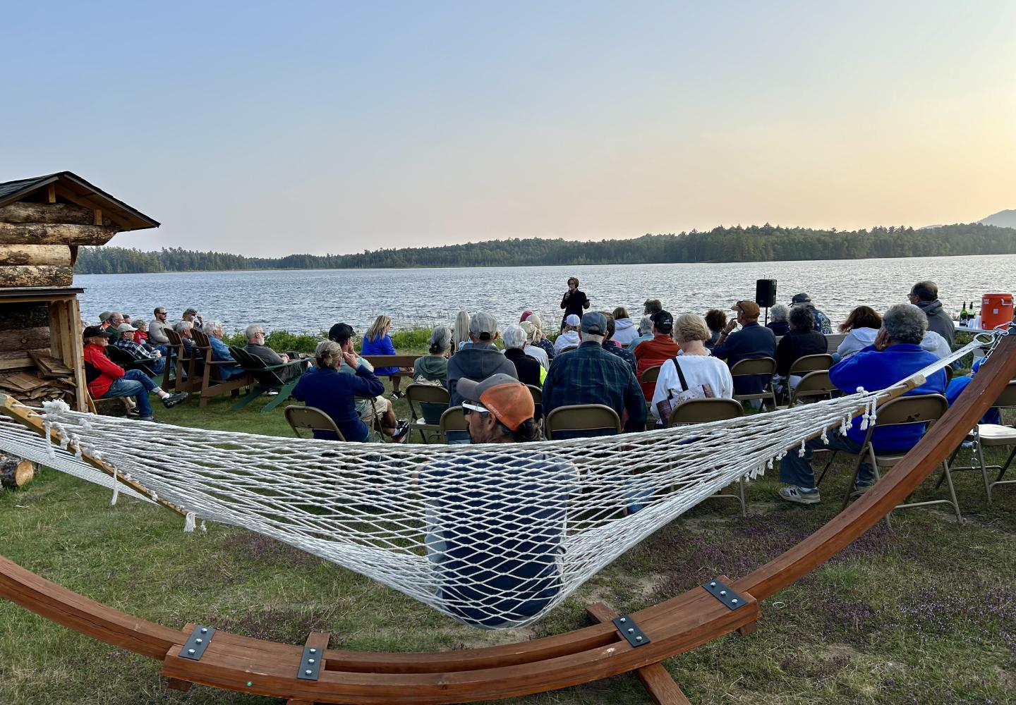 New York Bicycling Coalition Executive Director Anne Savage leads a sunset fireside chat about NYBC during the Weekender at Paul Smith's College.