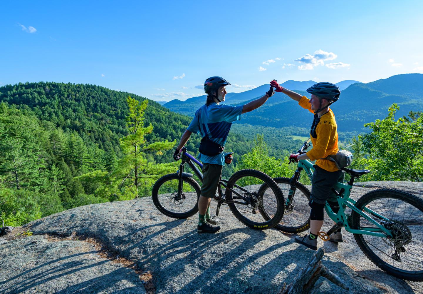 Mountain bikers celebrate at the top of Otis Mountain in Elizabethtown.