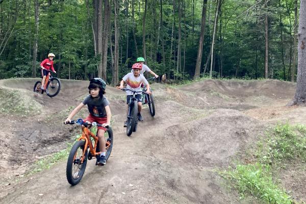 Local kids enjoy the new pump track built by Saranac Lake Innovative Cycling Kids and the Town of Harrietstown