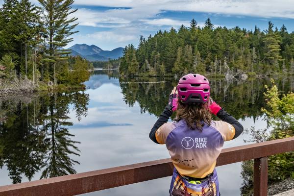 A rider takes a photo of Boreas Ponds during the Handlebarley Gravel Weekend
