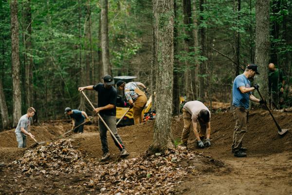 Members of the Barkeater Trails Alliance work on a new flow trail at Craig Wood in Lake Placid.