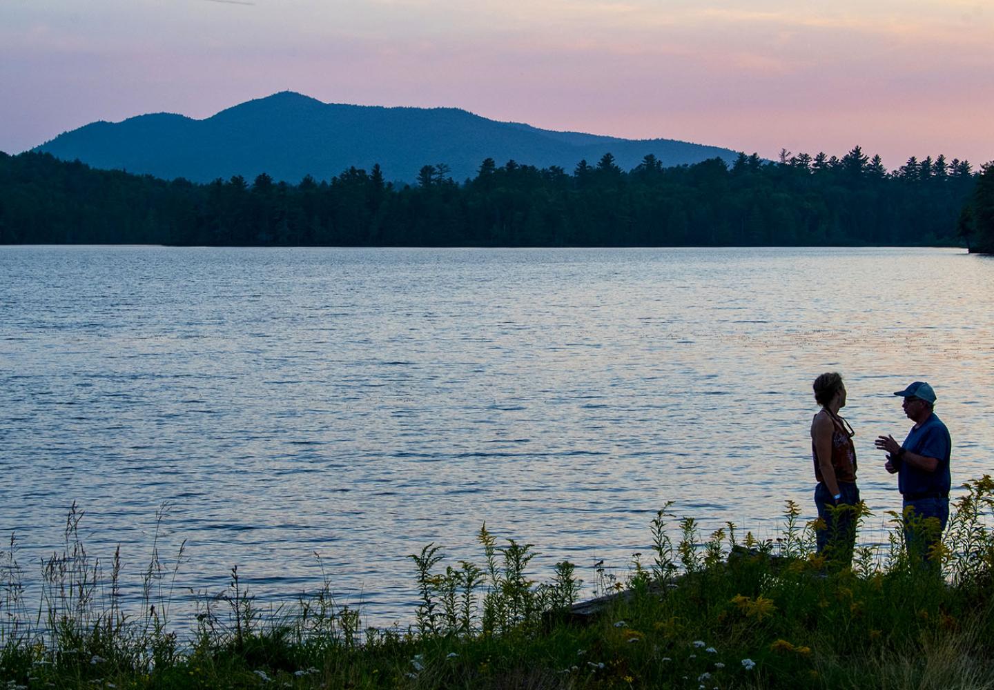 Sunset chats by the lakeside during the Weekender at Paul Smith's College.
