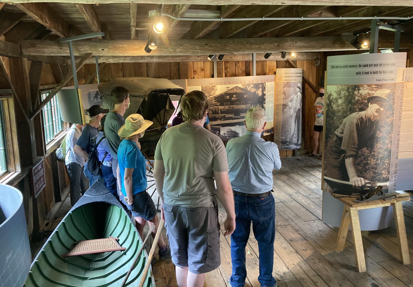 Guest tour one of the many buildings while Great Camp Sagamore staff share the history.