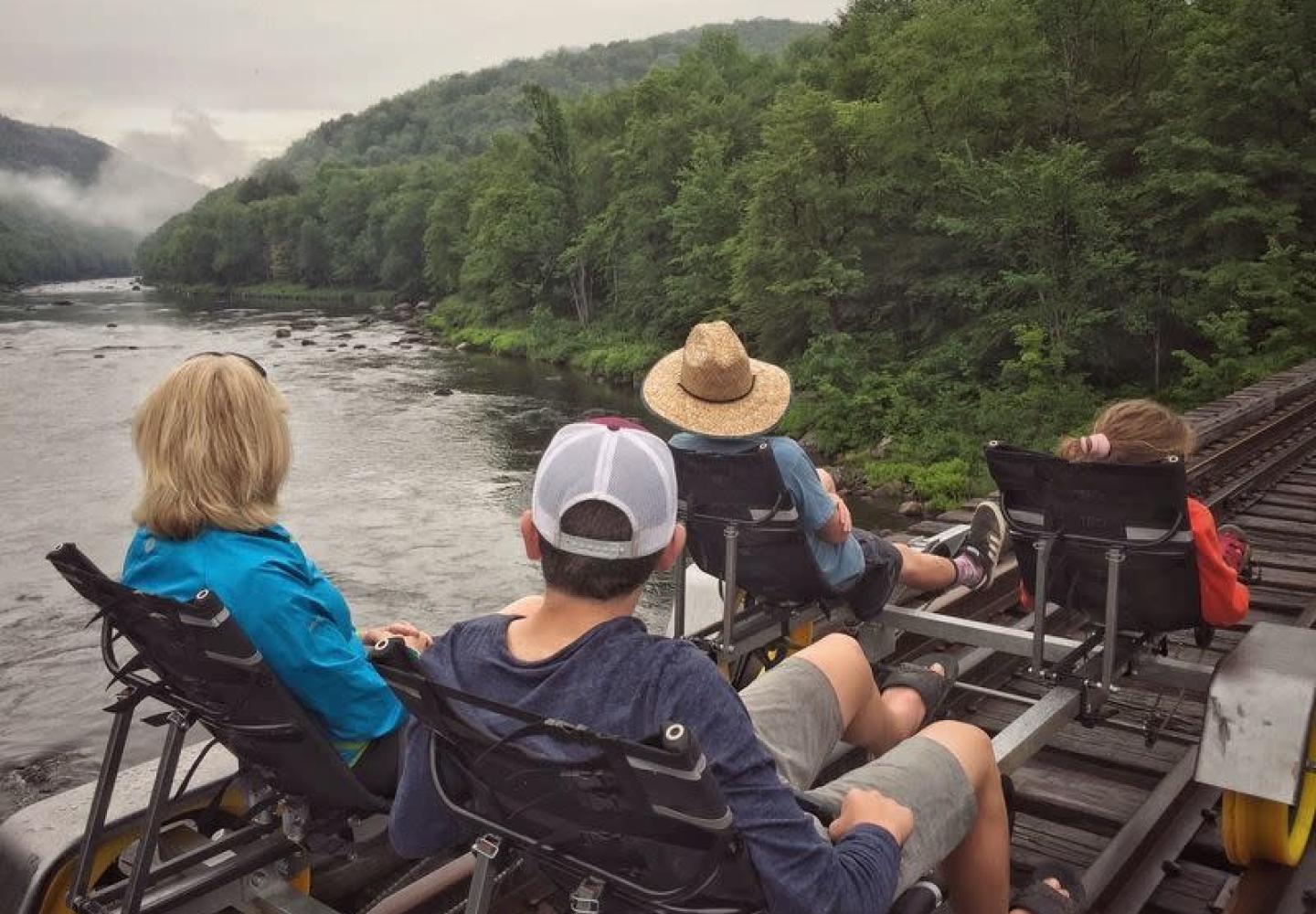 People pedal over the Hudson River on a rail bike.