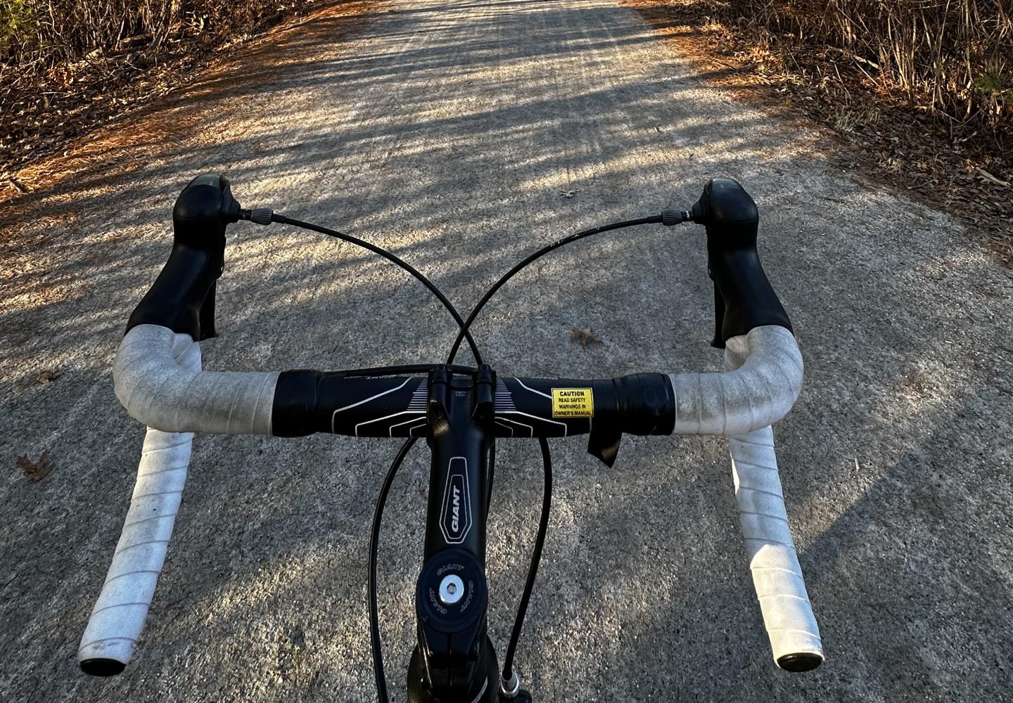 A POV view of a stone dust surfaced Upper Charles trail.