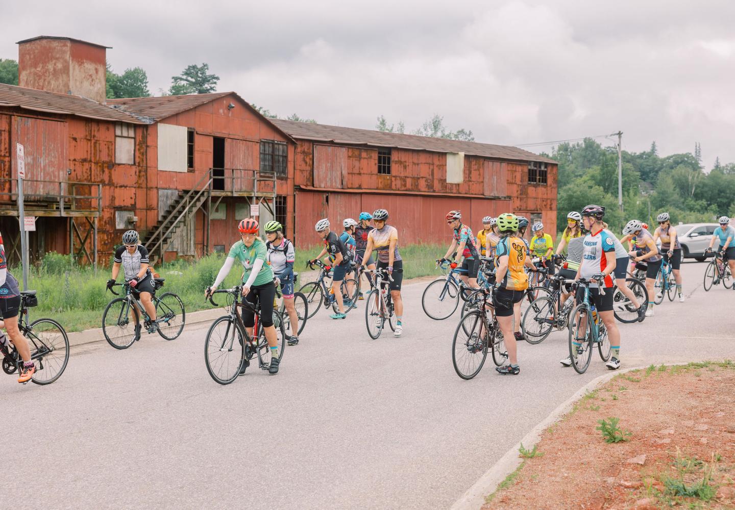 Riders pedal away from the future home of Play ADK en route to Norman Ridge Farmstead. 