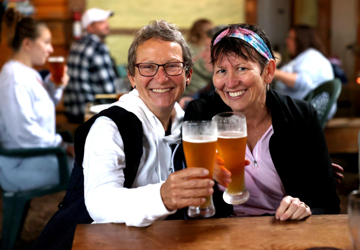 Cyclists enjoy the dry pavilion at Ausable Brewing Co. and some delicious beverages following Bike the Barns, a fundraiser for the Adirondack North Country Association.