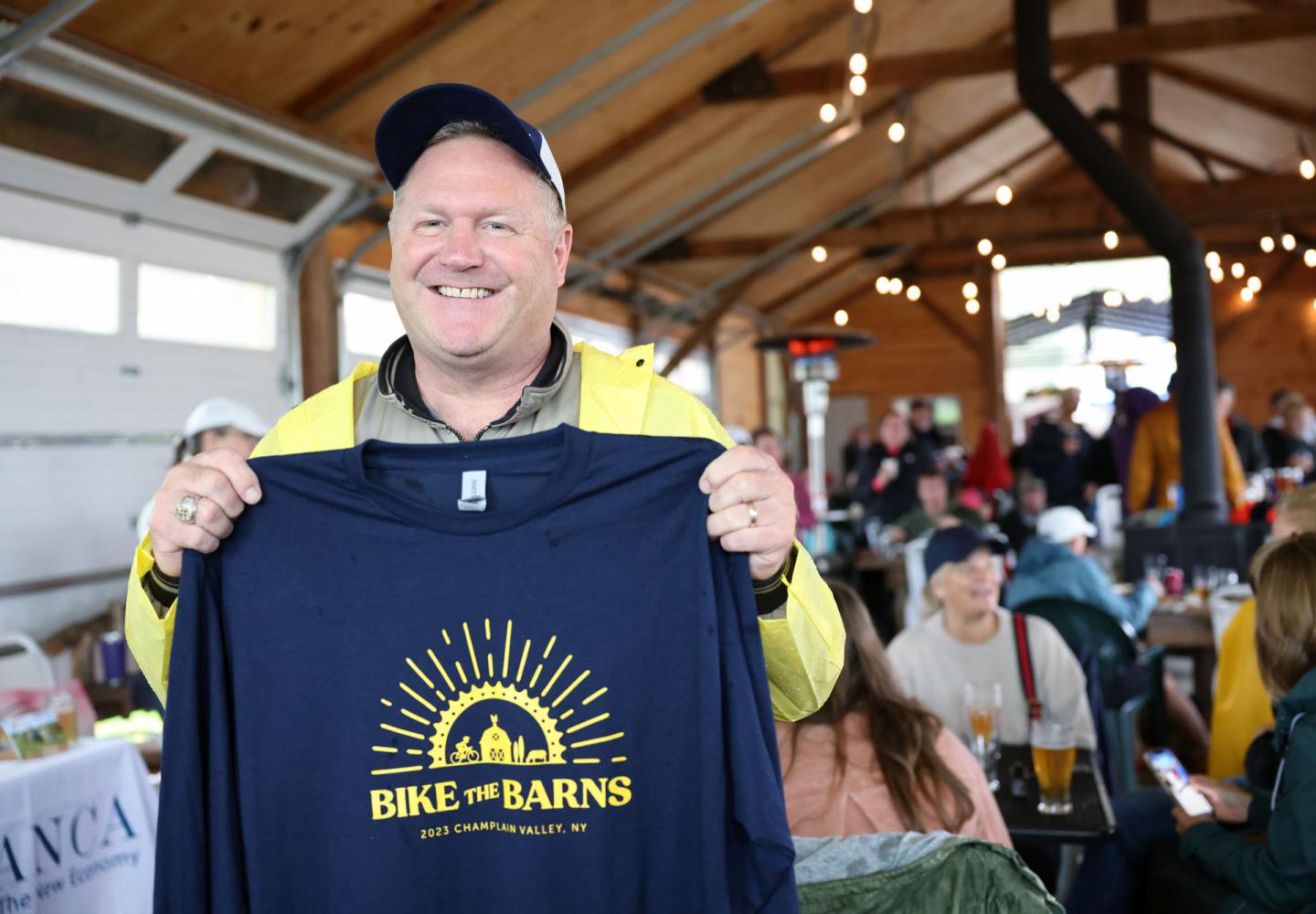 A rider shows off the 2023 Bike the Barns T-Shirt