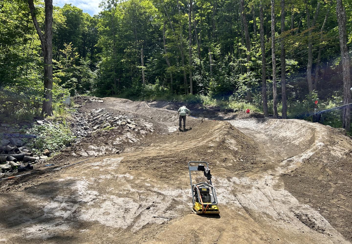 The Backslope Trail Building team shapes a dual slalom section where riders will vie for the fastest choice.