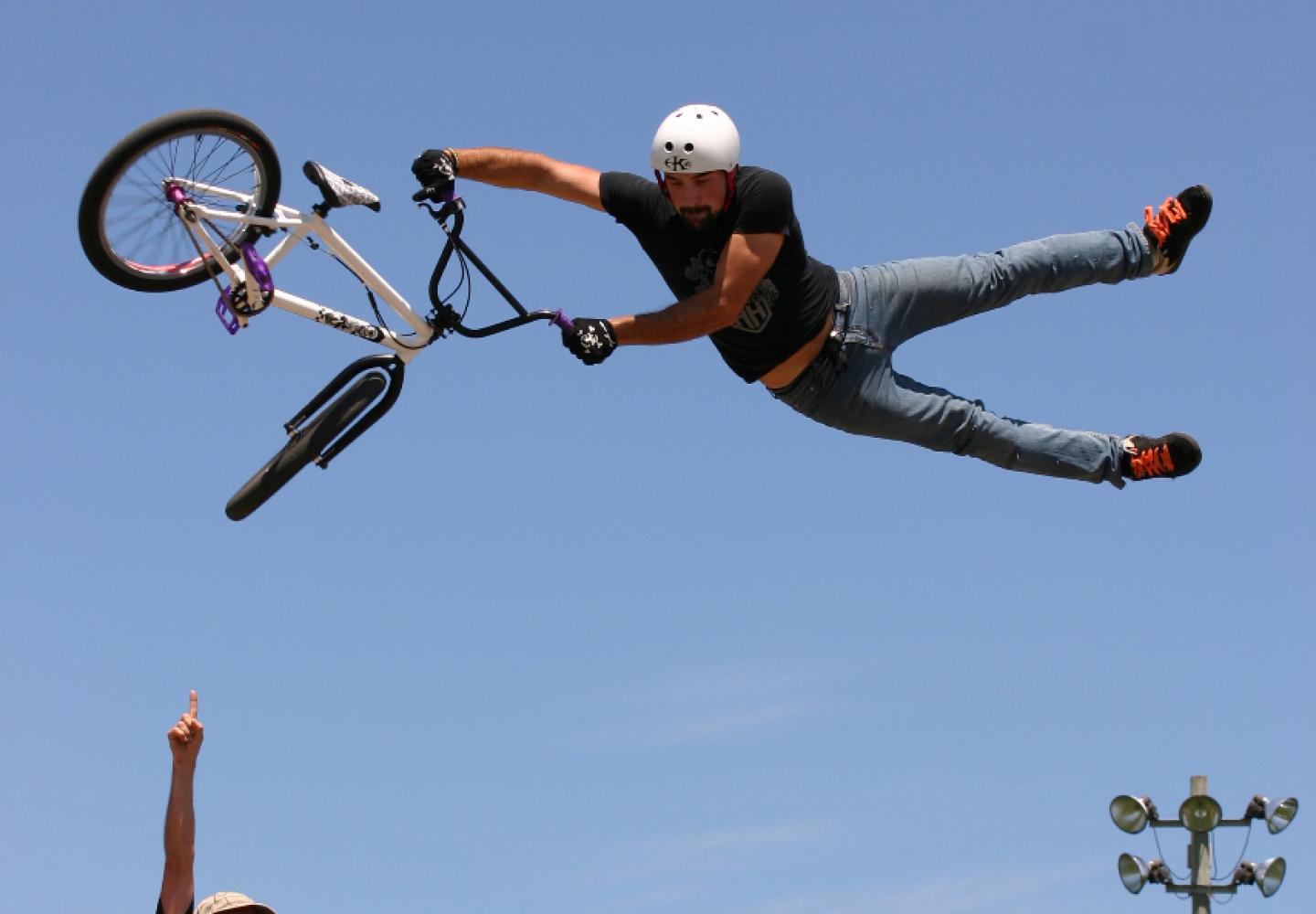 A BMX cyclists soars during a stunt show.