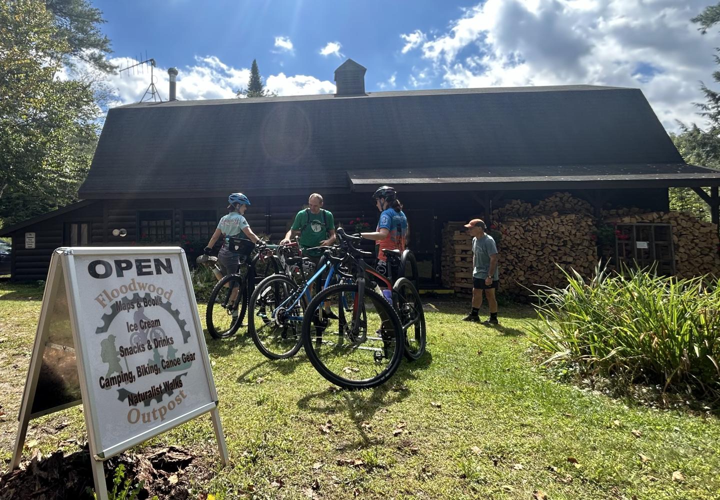 Cyclists enjoy a stop at the Floodwood Outpost located at the end of Phase 2 of the Adirondack Rail Trail.