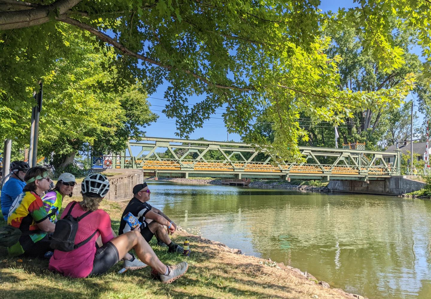 Cyclist relax along the Erie Canal during Cycle the Erie Canal hosted by Parks & Trails New York