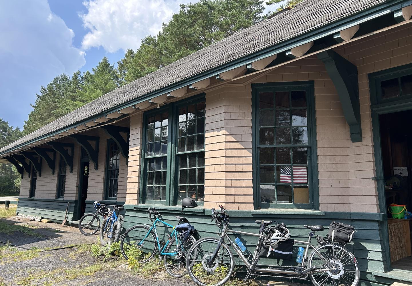 Bicycles lean against a historic train depot at Charlie's Inn