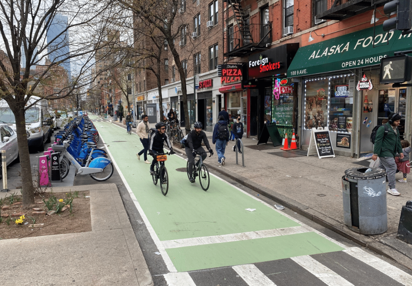 Bicyclists utilize a protected bike lane in New York City.