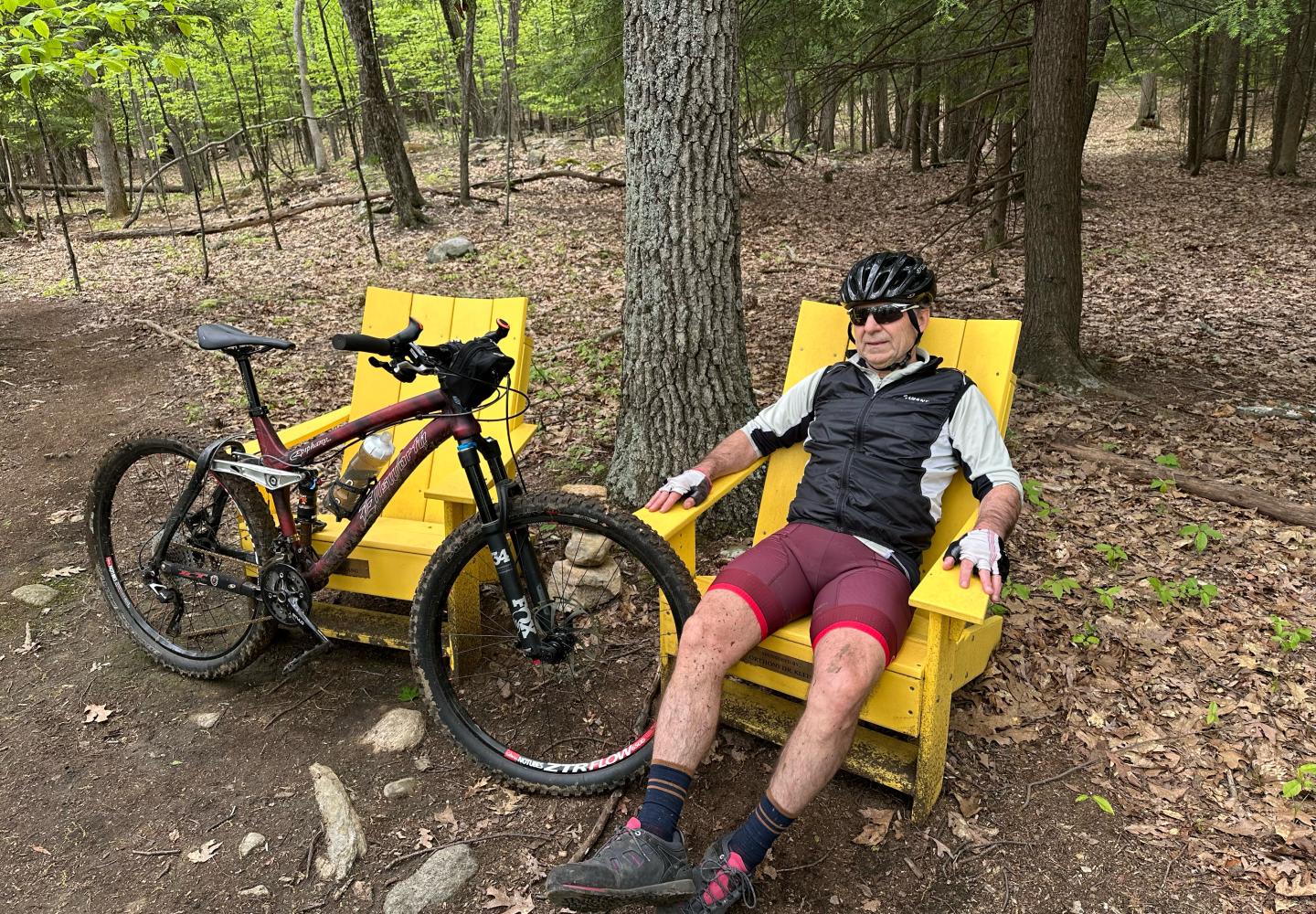 Tim Peartree relaxes in an Adirondack chair just off the Headlands trail.